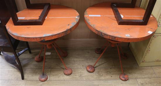 A pair of red painted circular metal occasional tables W.76cm